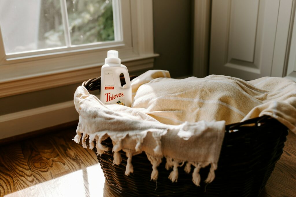 Finding the Best Detergent Scents for Your Preferences - a bottle of detergent sitting on top of a blanket